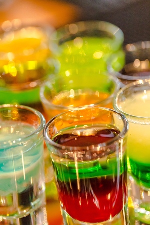 Barman serving colorful cocktails in a hotel barの写真素材