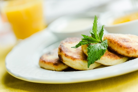 cottage cheese pancake with sour cream and syrupの写真素材