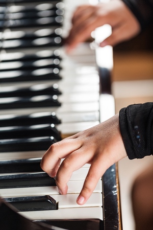 Playing a Piano (Childs hands)の写真素材