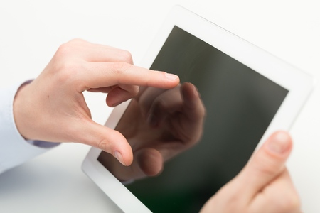 Business person analyzing financial statistics displayed on the tablet screen