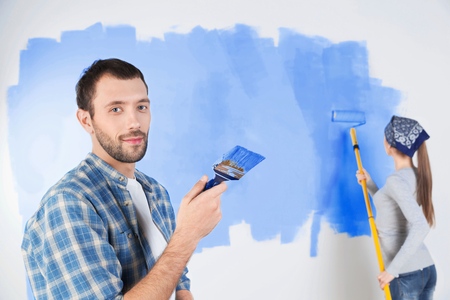 Young Couple Painting a Wallの写真素材