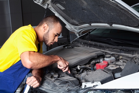 Auto Mechanic Checking the Engine of a Carの写真素材