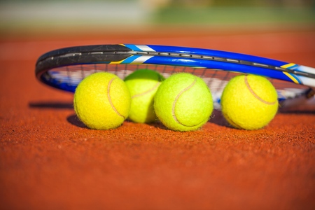 Tennis Racket and Balls on a Tennis Courtの写真素材