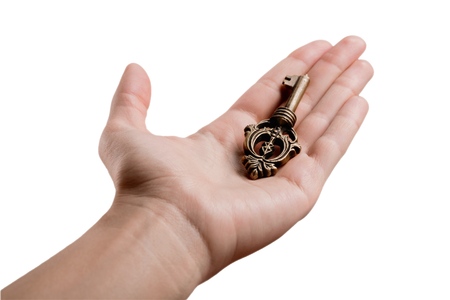 Vintage key in hand isolated on whiteの写真素材