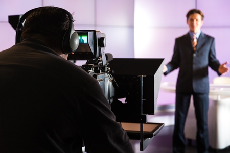 Closeup of a Camera Operator Filming an Anchormanの写真素材