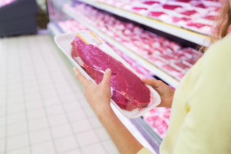 Closeup of a Customer Buying Meat in a Supermarketの写真素材