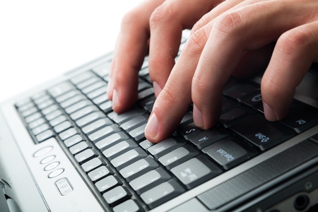 Closeup of a Person Typing on a Laptop Keyboard