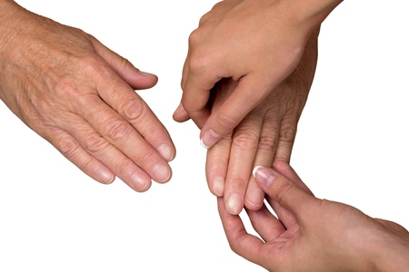 Young Womans Hands Touching and Holding an Old Womans Hand