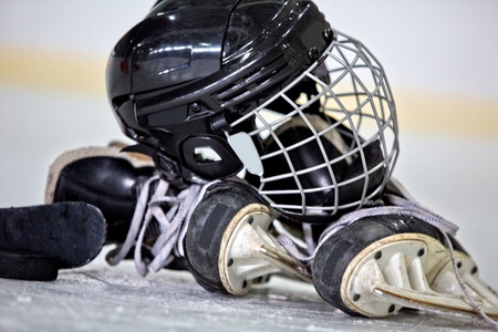 Hockey Helmet, Puck, Stick and Skates on Hockey Rinkの写真素材