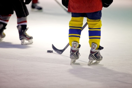 Closeup of Child Legs in Ice Hockey in Arenaの写真素材