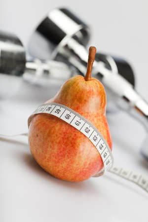 A Red and Yellow Pear and a Measuring Tapeの写真素材