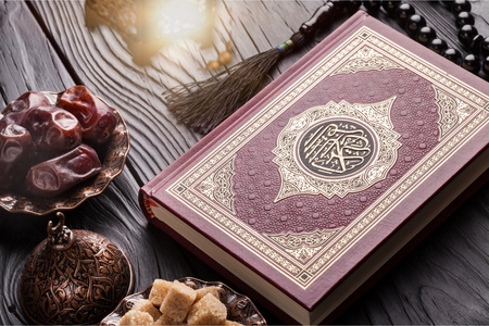Holy Book Quran with rosary