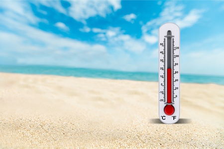 Thermometer on sand showing high temperature
