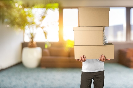 Man with cardboard boxes on backgroundの写真素材