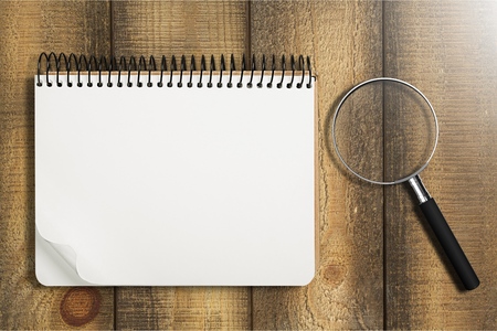 magnifying glass and notebookの写真素材
