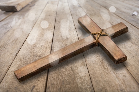 Wooden Christian cross on a tableの写真素材