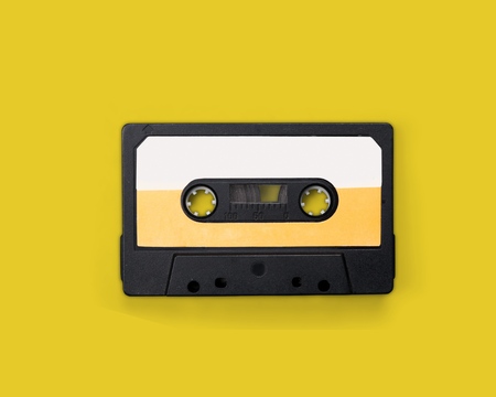 Audio cassete on yellow background
