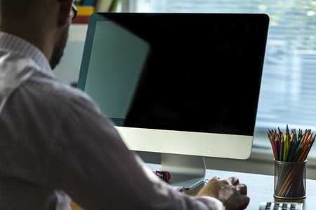 Young businessman working on laptop in the office