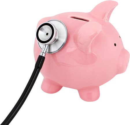 Piggy bank with a stethoscope - financial check up conceptの写真素材