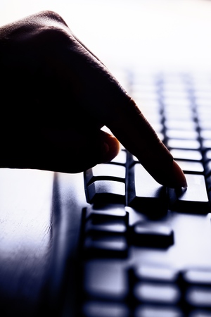 Finger Pressing the Enter Key on a Keyboardの写真素材