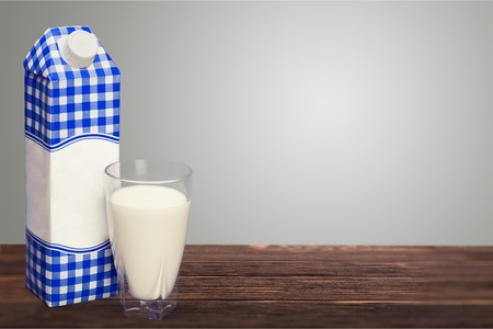 Milk carton package and glass on backgroundの写真素材