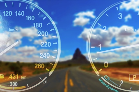Speedometers on road background with blue cloudy