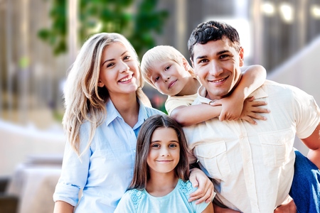 Beautiful smiling family sitting at sofa