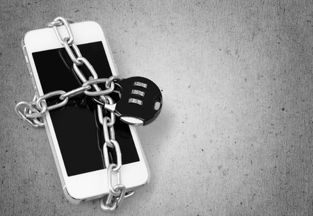 Modern smartphone with combination lock padlock. Conceptの写真素材