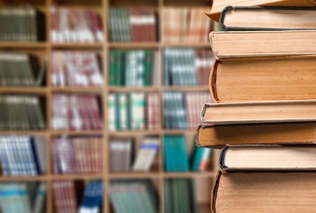 Old Books stacked in libraryの写真素材