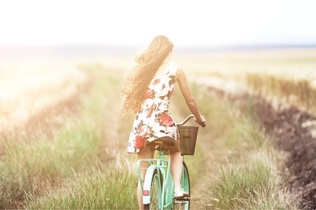 Retro bicycle in summer grass fieldの写真素材
