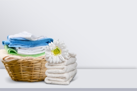 Laundry Basket with colorful towels on backgroundの写真素材
