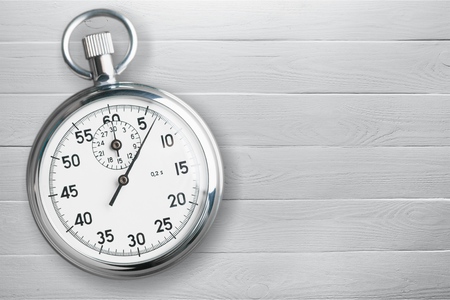 Analogue metal stopwatch on woden backgroundの写真素材