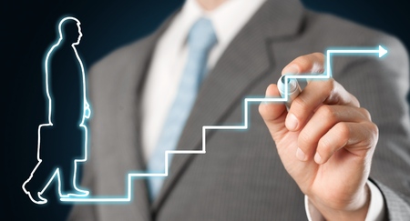 Businessman holding digital glowing graph with silhouetteの写真素材