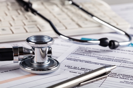 Stethoscope with Computer Keyboard and Health Insurance Document