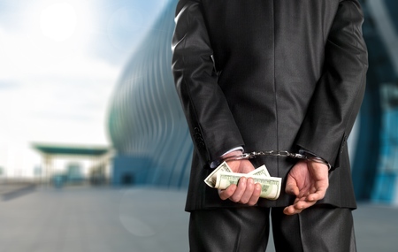 Male hands in handcuffs and currecity