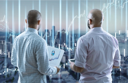 Happy business colleagues in modern office using