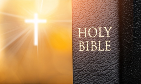 Holy bible and light croos