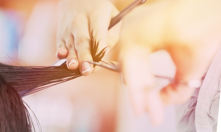 Man having a haircut with scissors on background