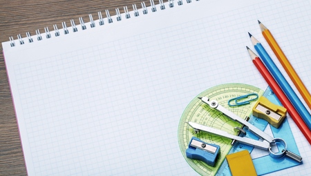 Mathematical instruments over the corner of a math graph paper with copy space for text. Math...