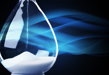 Sand running through the bulbs of an hourglass