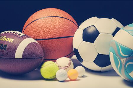 Set of balls for different sports on white table background