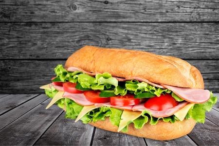 Ham and cheese salad submarine sandwich from freshly cut baguetteの写真素材