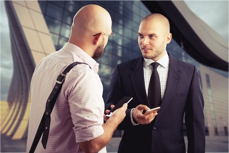 Happy business colleagues in modern office using tablet