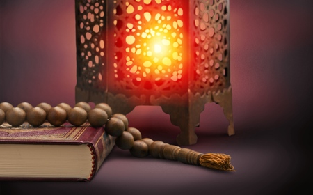 Three months.Islamic Holy Book Quran with rosary beads under soft light on white background. Ramadan concept .の写真素材