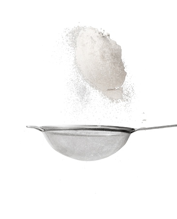 Strainer with flour isolated on a white background.の写真素材