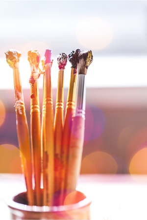 Brushes in a glass jar isolated on a table
