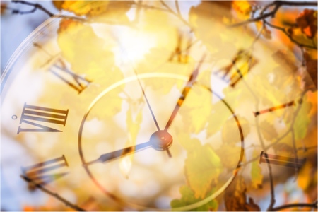 Old retro clock on autumn background