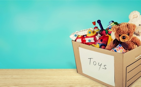 Toys collection in box on a wooden tableの写真素材