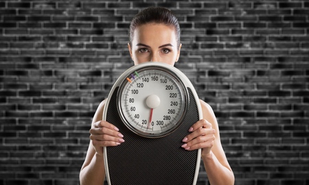 Woman measuring perfect shape of beautiful waistの写真素材