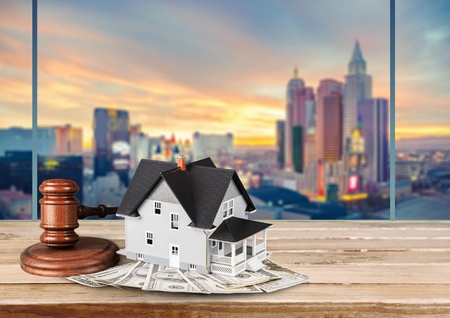 Wooden judge gavel and toy house